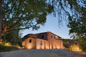 an old stone building with lights on a road at Antica Quercia Villa & Spa in Chianciano Terme