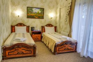 a bedroom with two beds and a window at Dayana Hotel in Simferopol