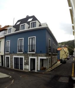 a blue house on the side of a street at Albergaria O Professor in Santa Cruz