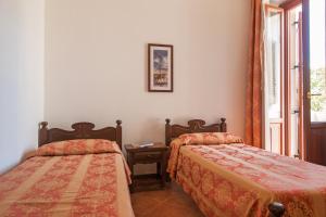 Voodi või voodid majutusasutuse Hotel Il Querceto toas