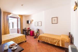 Postel nebo postele na pokoji v ubytování Hotel Il Querceto