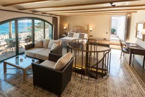 a hotel room with a bed and a living room at Hotel Diana in Tossa de Mar