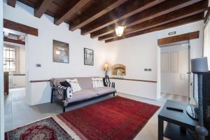 威尼斯的住宿－威尼塞塞拉卡薩桑托斯特法諾公寓，带沙发和红色地毯的客厅