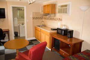 a small kitchen with a microwave and a table at Budget Inn in Luray