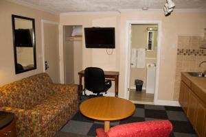 a living room with a couch and a table at Budget Inn in Luray +6 photos