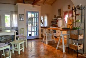 a kitchen with a table and some chairs in a room at Corfu Town Garden Cottage in Corfu