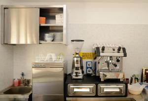 a kitchen with a coffee maker on a counter at Locanda Marita in Finale Ligure