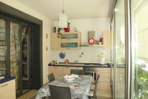 a kitchen with a table and a table and chairs at Pretty Home in Acireale
