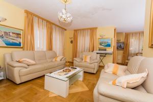 a living room with two couches and a coffee table at Apartment Holiday in Trogir