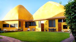 a yellow house with two domes on top of it at Las Casitas in Rincon de Guayabitos