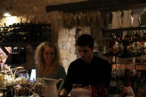 a man and a woman standing in a bar at Teresa Country Lodge in Eptalofos