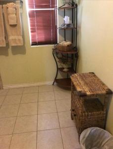 a bathroom with a tiled floor and a shelf with towels at Dominion Hotel in Minden