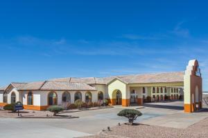 a large building with trees in the courtyard at Days Inn by Wyndham Holbrook in Holbrook