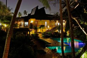 a resort with a swimming pool at night at The Warwick Fiji in Korolevu