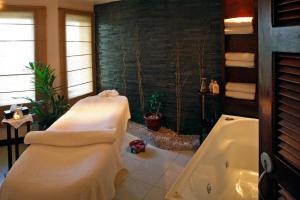 a bathroom with a bath tub and a bath tub at The Warwick Fiji in Korolevu