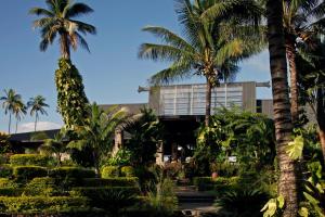 a building with palm trees in front of it at The Warwick Fiji in Korolevu