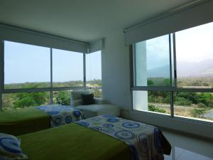 Ένα ή περισσότερα κρεβάτια σε δωμάτιο στο Costa Azul Suites 401