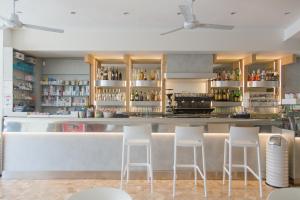 a bar with white stools in a restaurant at Hotel Turismo Europa in Casal Borsetti