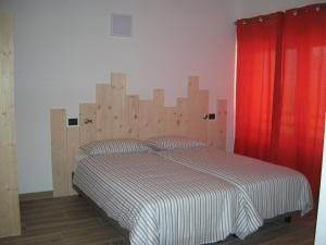 Postel nebo postele na pokoji v ubytování AGRITURISMO MASO PERTENER -adults friendly-