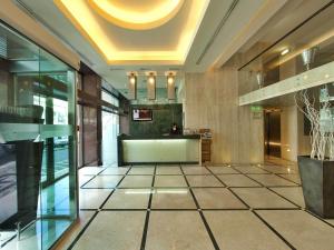 a lobby with a large tile floor and a ceiling at TURIM Alameda Hotel in Lisbon +17 photos