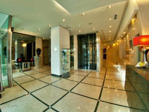 a large lobby with a large room with glass doors at TURIM Ibéria Hotel in Lisbon