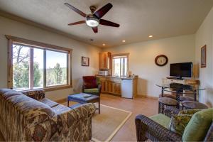a living room with couches and a ceiling fan at Ridgetop Hideaway in Hatch