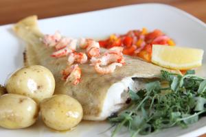 a plate of fish with shrimp and potatoes and vegetables at Bowood Park Hotel in Camelford