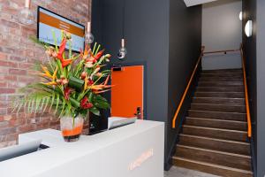 a lobby with stairs and a vase of flowers at easyHotel Birmingham in Birmingham