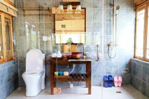 a bathroom with a toilet and a sink and a shower at Shangri-La mid - mountain homestay in Shangri-La +120 photos