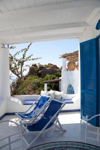 a blue chair on a porch with a view of the ocean at Casa Prete in Panarea
