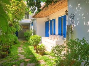 a house with blue doors and a walkway at Costa Village Pool Villa in Jomtien Beach