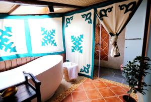 a bathroom with a tub and a shower with blue paint at Shangri-La mid - mountain homestay in Shangri-La