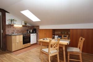 a kitchen with a wooden table and chairs in it at Haus Lukaswinkl in Schönau am Königssee