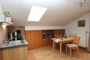 a kitchen with a sink and a table with a tablektop at Haus Lukaswinkl in Schönau am Königssee