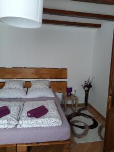 um quarto com uma cama com almofadas roxas em Apartmani Stonewood em Zagreb