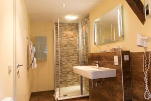 a bathroom with a sink and a shower at Gästehaus am Schlossberg in Bernkastel-Kues +13 photos