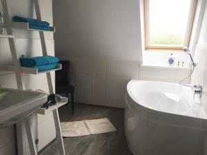 a bathroom with a toilet and a sink and a tub at Studio Templin in Templin