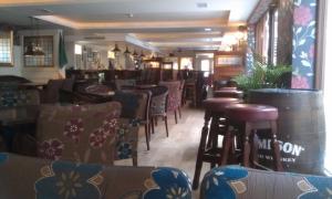 a restaurant with a bunch of chairs and tables at Forty Four Main Street in Swords