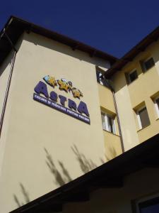 a sign on the side of a building at Hotel Astra in Braşov