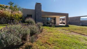 a house with a grassy yard in front of it at Casa hermosa vista in Villa Carlos Paz