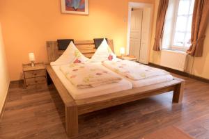 a bedroom with a wooden bed with two candles on it at Gästehaus am Schlossberg in Bernkastel-Kues