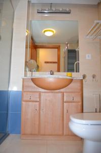 y baño con lavabo de madera y aseo. en Arona 1 - 6807, en Mar de Cristal