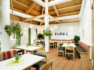 a restaurant with wooden ceilings and tables and chairs at Haus Feldberg-Falkau in Feldberg