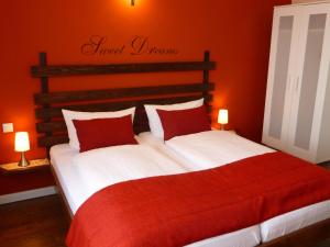1 dormitorio con 2 camas con sábanas rojas y blancas en Haus Strandperle, en Dahme