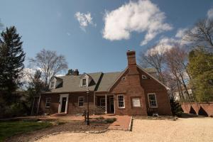 an old brick building with a white roof at Stafford House Bed & Breakfast in Fairfax