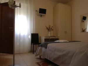 a bedroom with a bed and a window and a television at Il Pentagono in Termoli