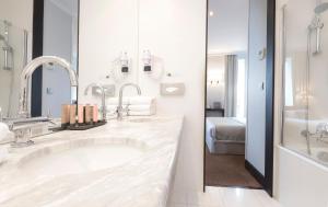 a white bathroom with a sink and a bed at Montfleuri in Paris +37 photos
