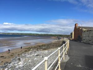 a view of a beach with people walking on the sand at Avondale Apartment Lahinch in Lahinch