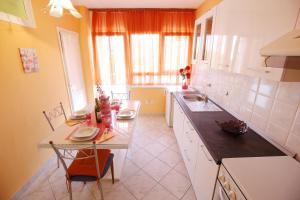 a kitchen with a table and a counter top at Apartment Angela in Zadar