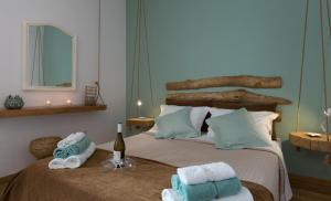 a bedroom with two beds with towels and a bottle of wine at Athens Wooden Studio in Athens
